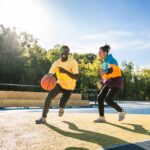 Multicultural group of young friends bonding outdoors and having fun - Stylish cool teens gathering at urban skate park